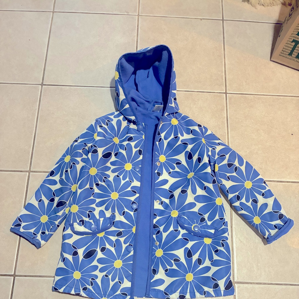 Warm waterproof, lightweight kids jacket. Blue, white, with yellow flowers.